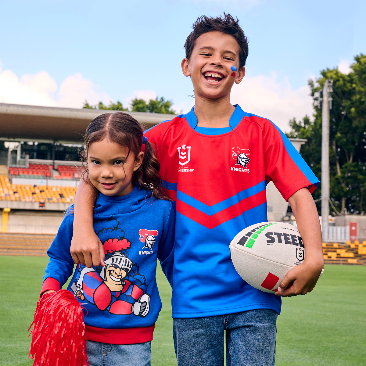 2 children wearing NRL jerseys