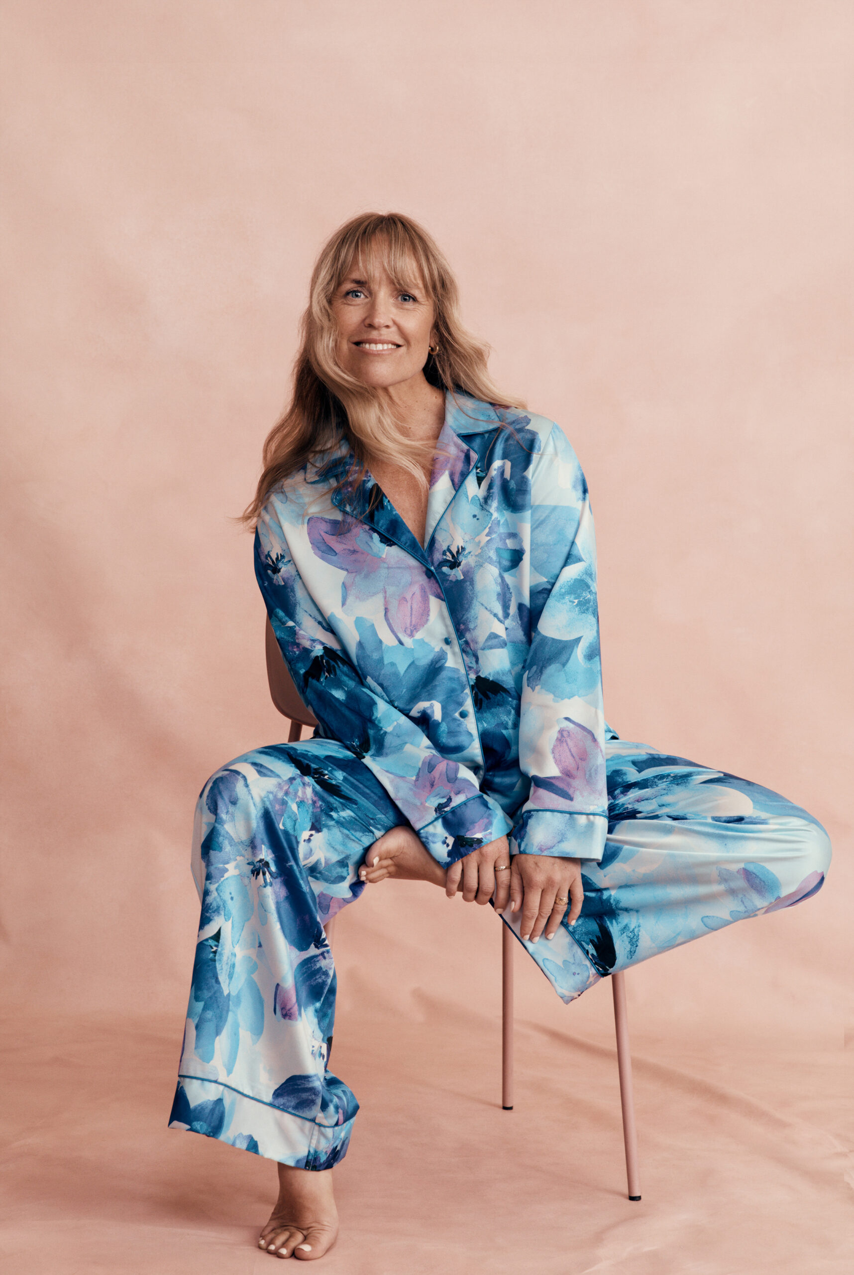mother sitting on a chair wearing blue floral pyjamas
