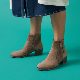 Female wearing light brown ankle boots