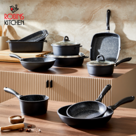 variety of black stone cookwear sitting on kitchen table