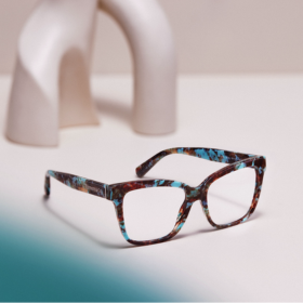 brown and green marbled glasses sitting on white bench