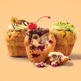 3 different flavoured muffins. Choc chip muffin as a bite taken out of it.